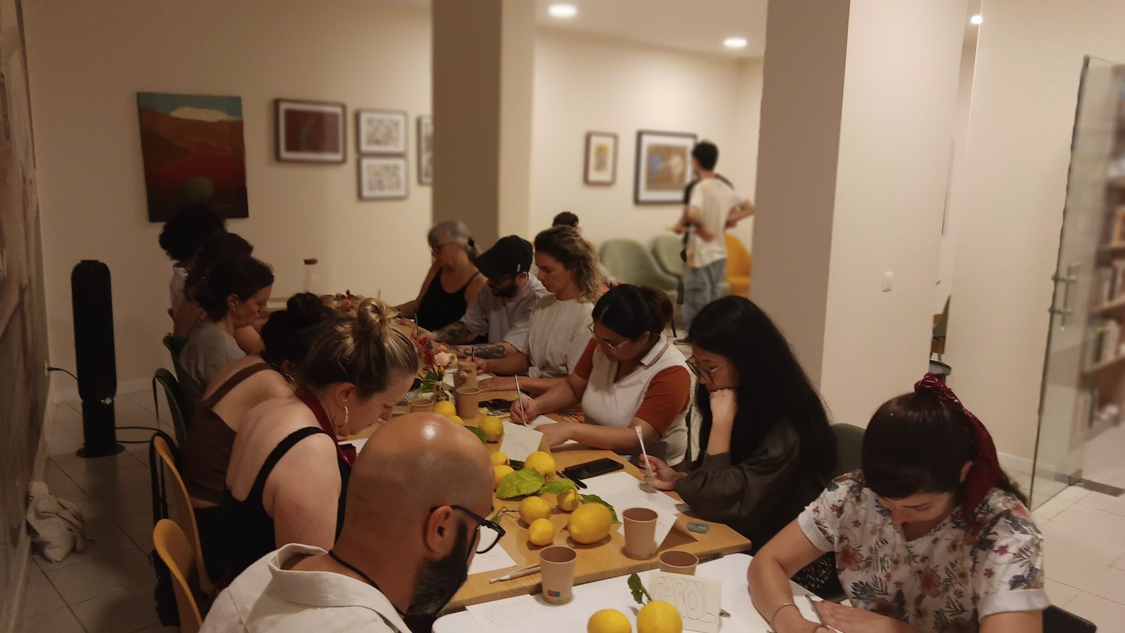 Group of adult learners around a table during a community workshop
